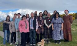A group picture of most of the steering committee members of the youth-led fund outside of the hobbit house.