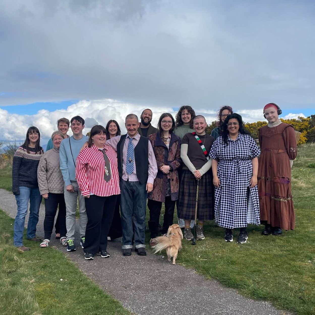 A group picture of most of the steering committee members of the youth-led fund outside of the hobbit house.